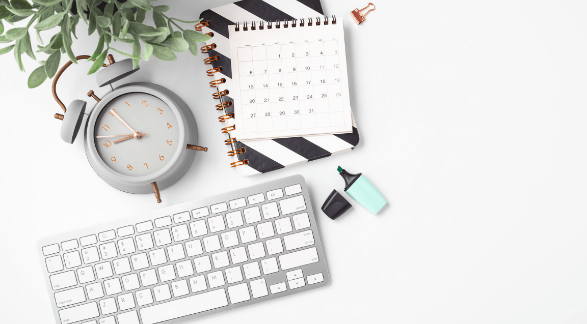 a keyboard and a calendar on a desk