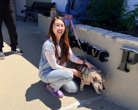 Dr. Chen with a dog outside